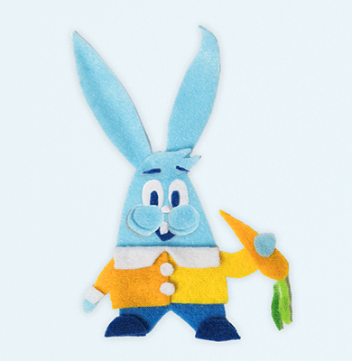 blue rabbit with orange sweater holding a carrot 