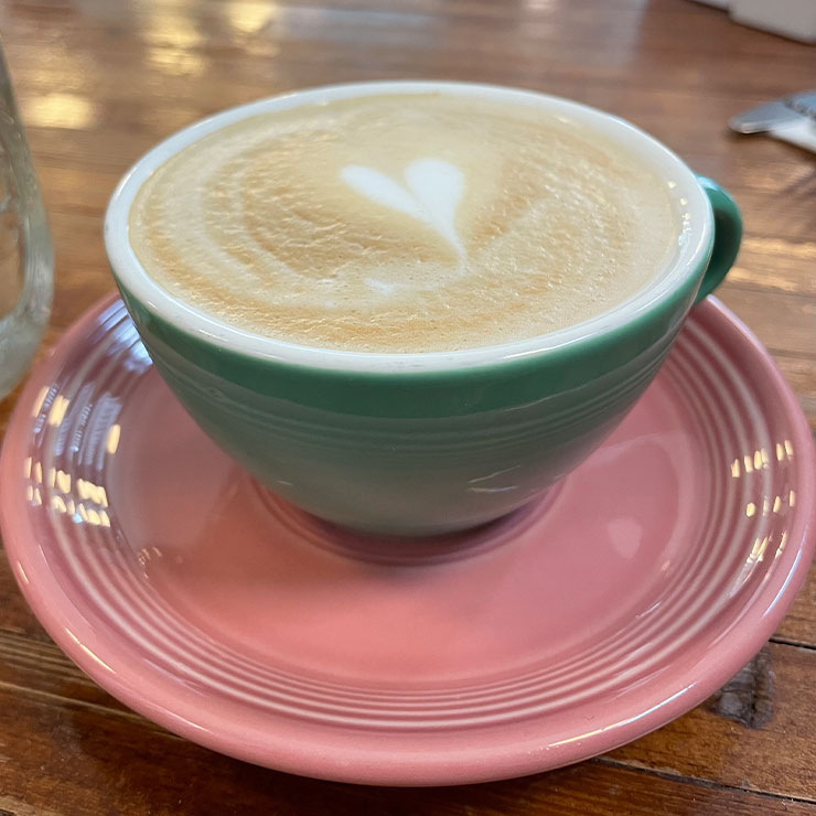 Cup of coffee, with a heart shape in the foam