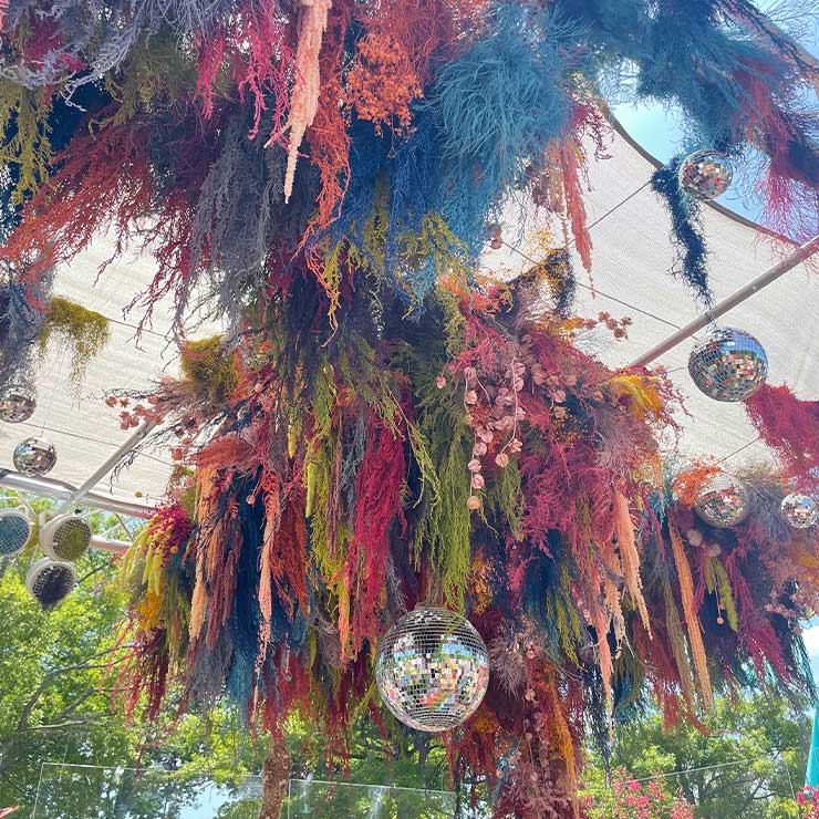 Flowers hanging from the ceiling with disco balls
