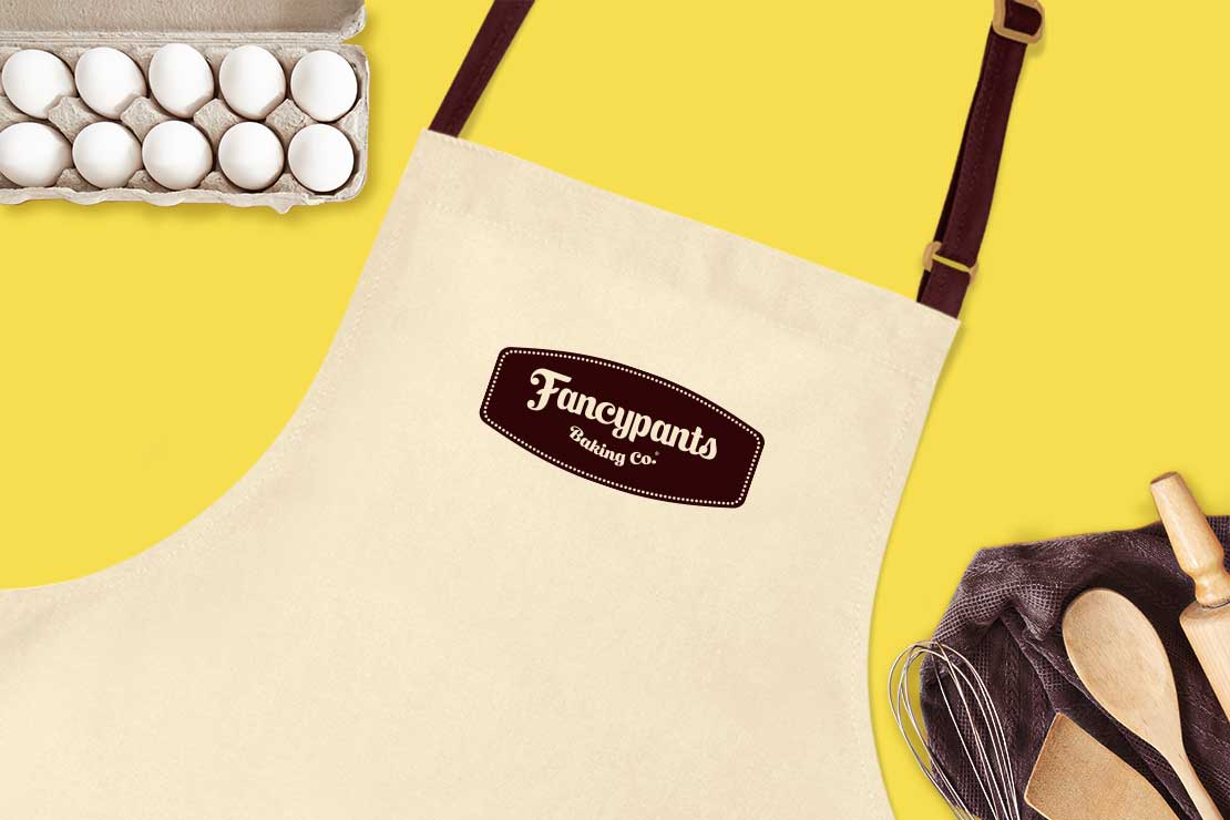 Fancypants logo on apron with dozen eggs