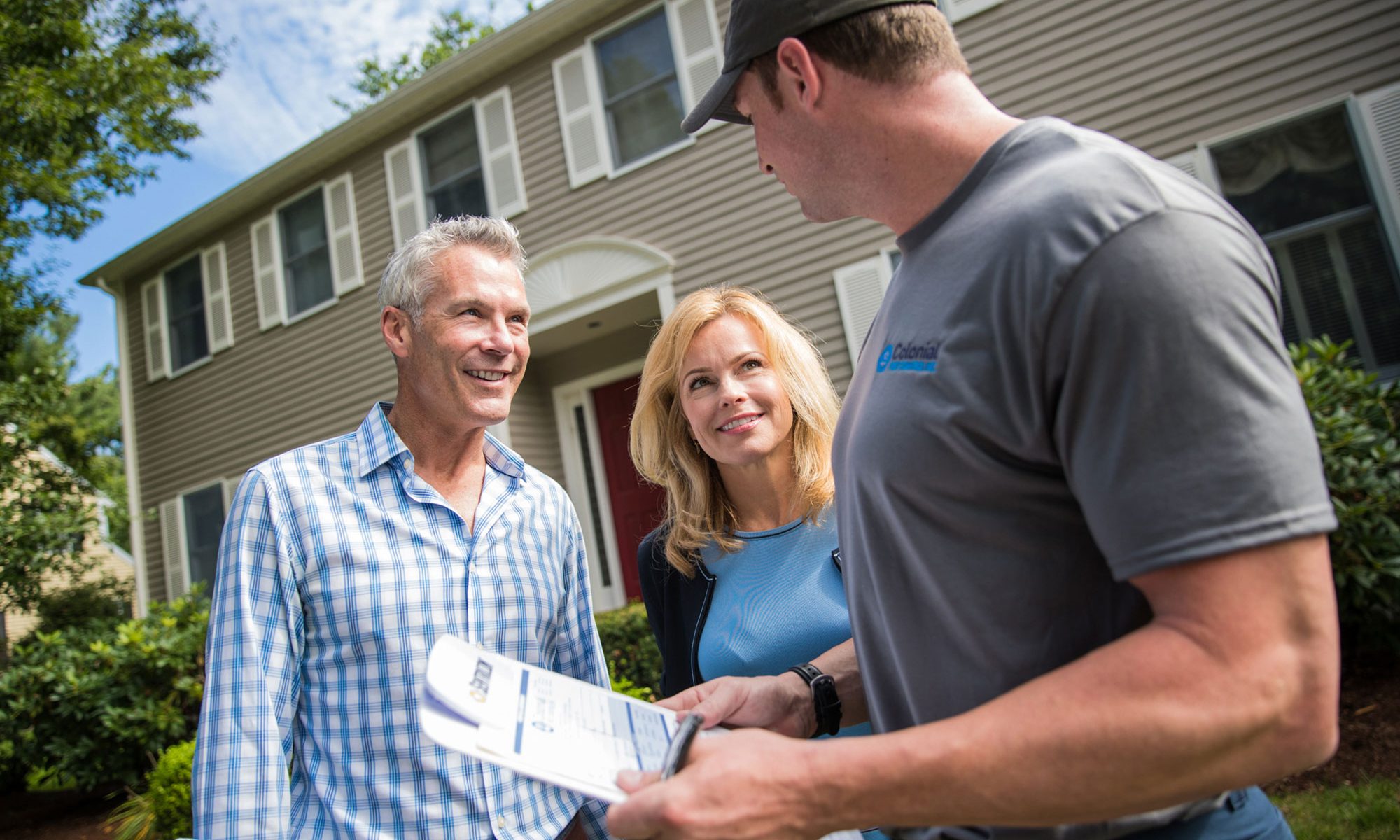 colonial pest employee talking to a man and woman