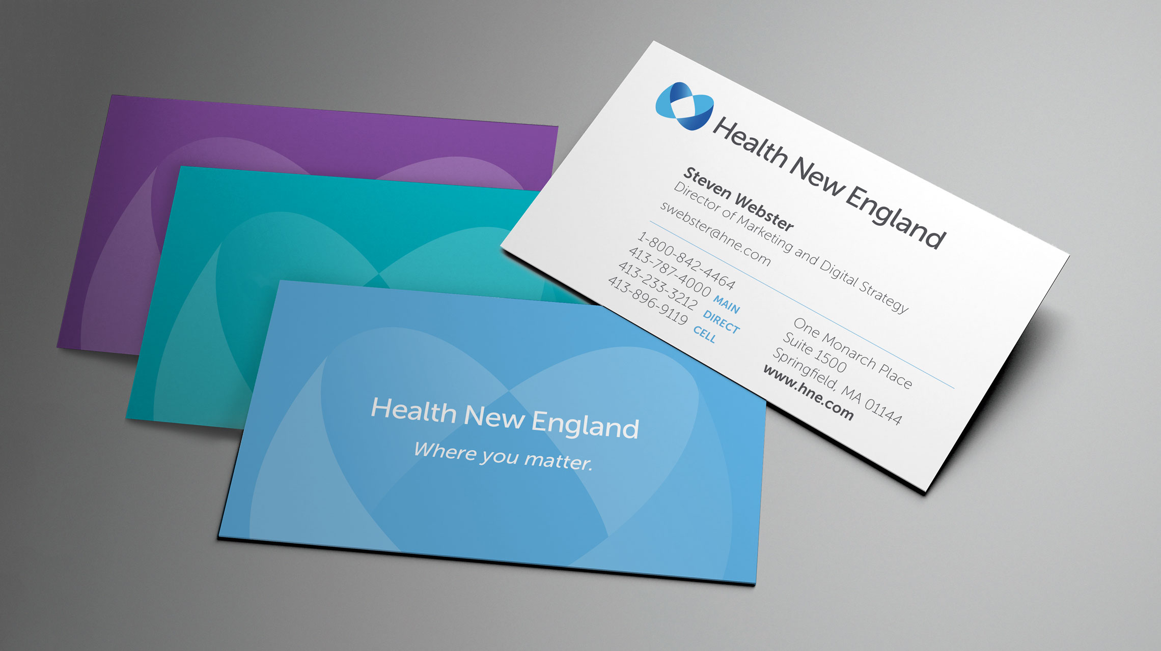 Health New England business cards in blue, teal, purple