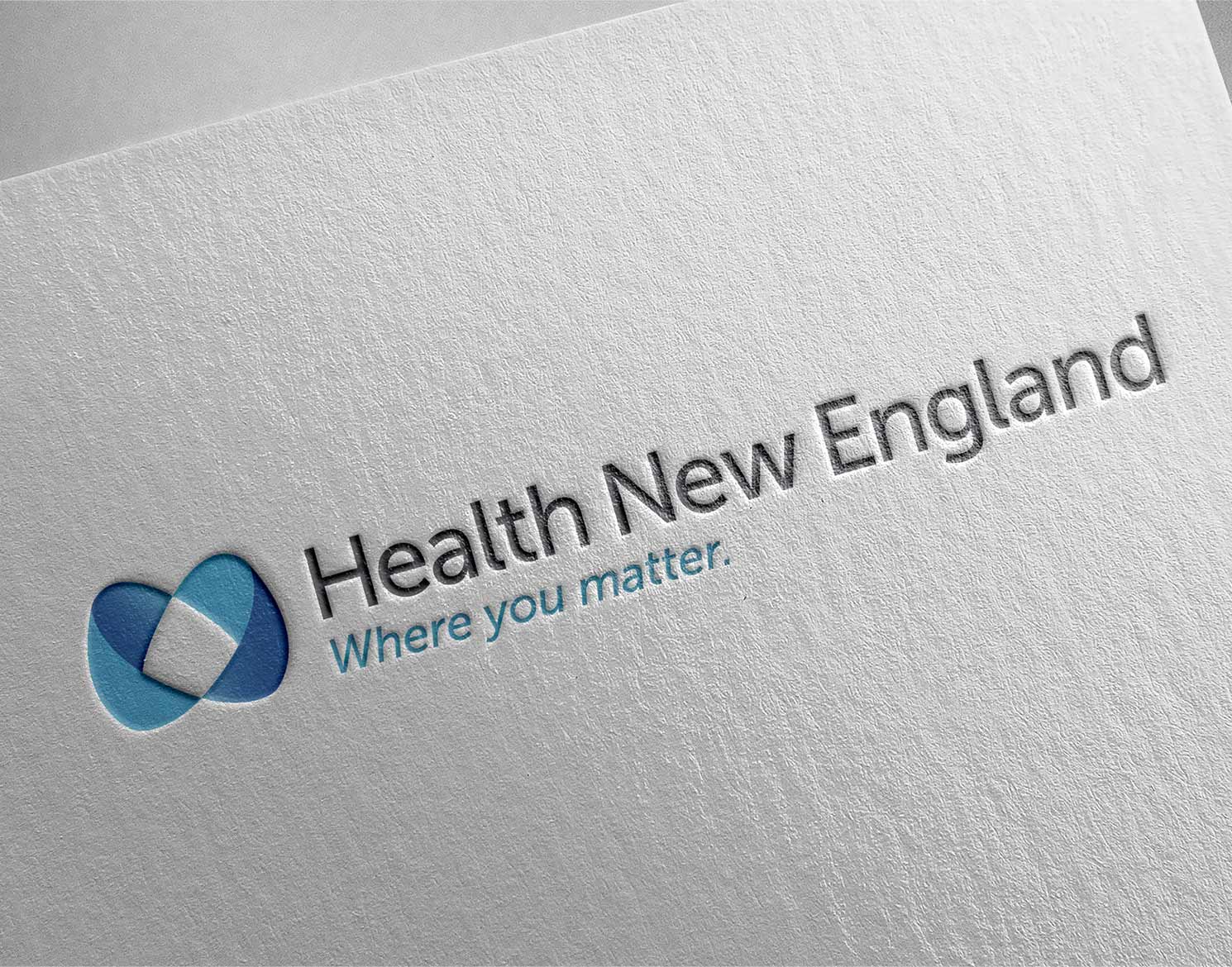 Health New England logo shown letterpressed on paper