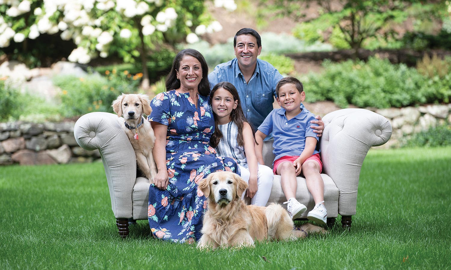 MSPCA-Angell portrait project fundraiser with donor family on couch outside with 2 dogs