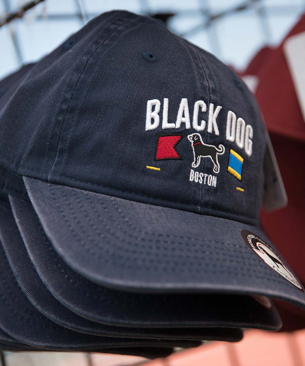 WOOFstock event photography showing Black Dog branded baseball caps