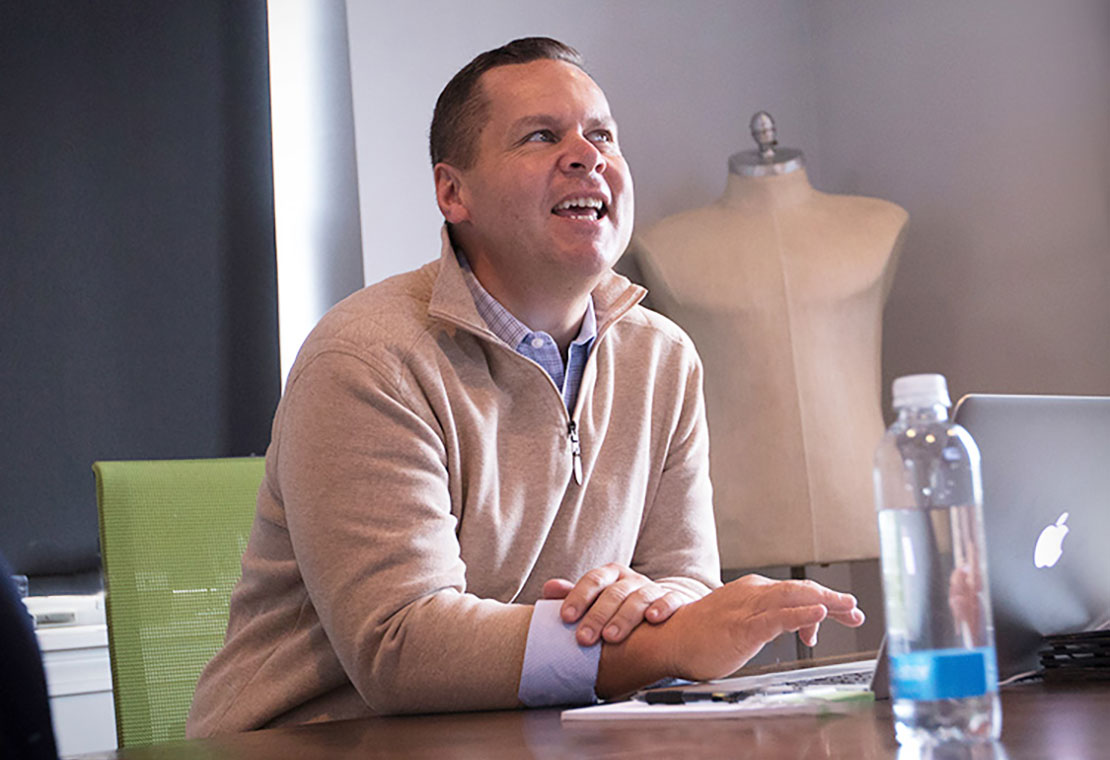 Dave Belyea sitting in conference room