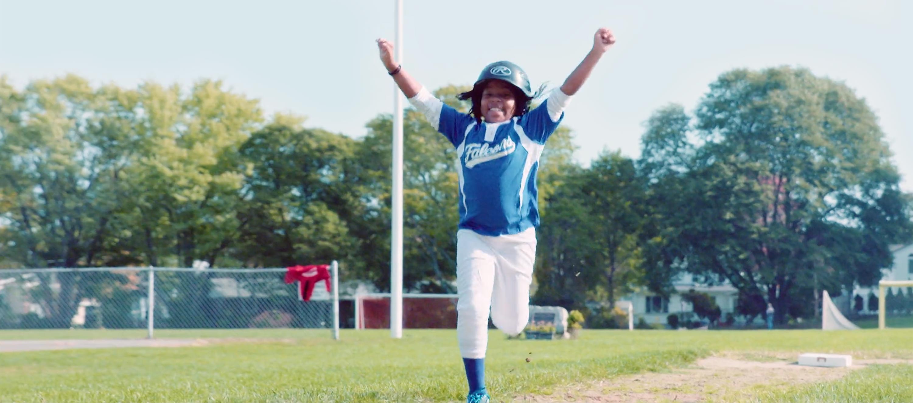 Good Sports "Why Sports?" video still shot of child running bases with hands raised