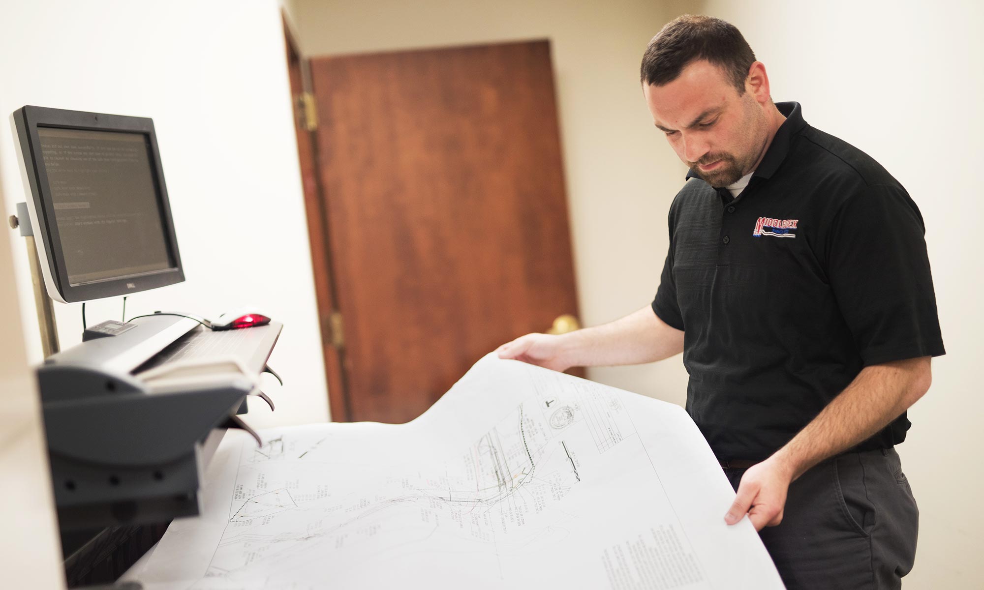 Middlesex Corporation photo of employee looking at blueprint