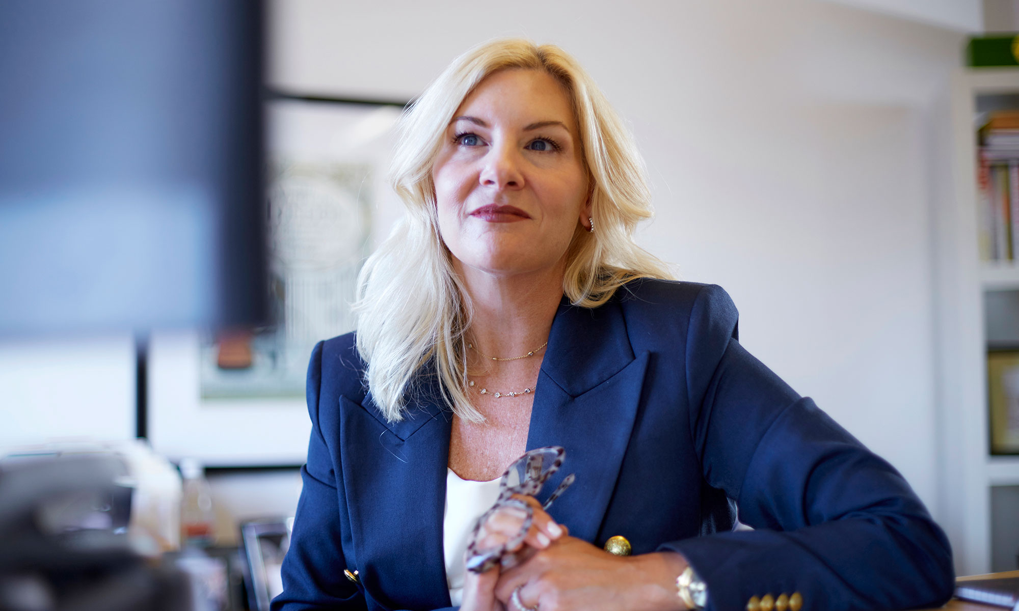 V2 Communications woman in blue blazer in office