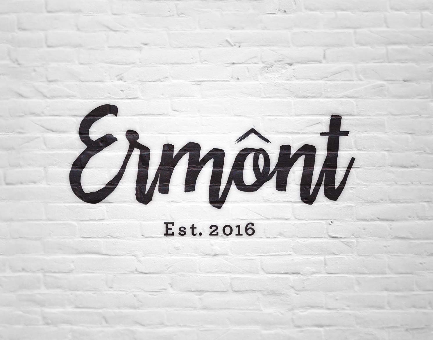 black Ermont logo on white wall