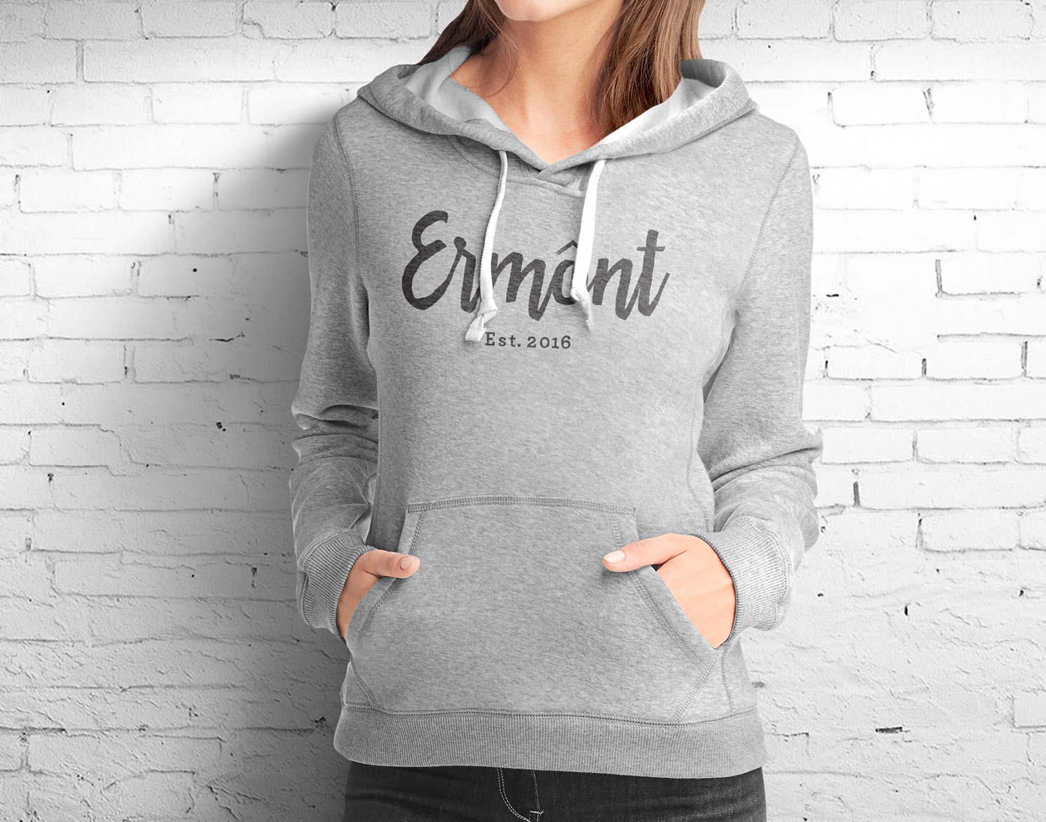 woman wearing a grey sweatshirt with Ermont logo on front