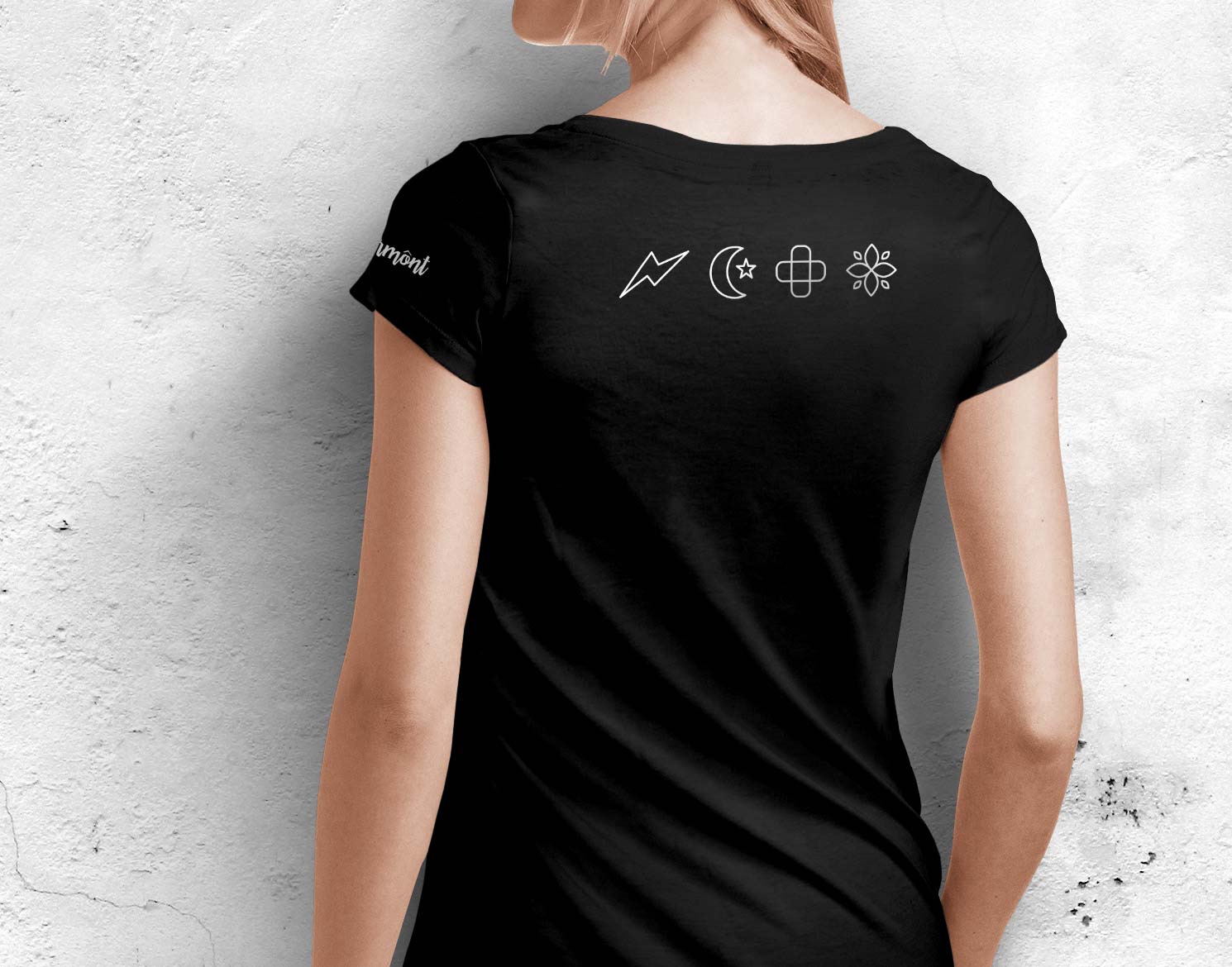 woman wearing a black t-shirt with Ermont icons on back