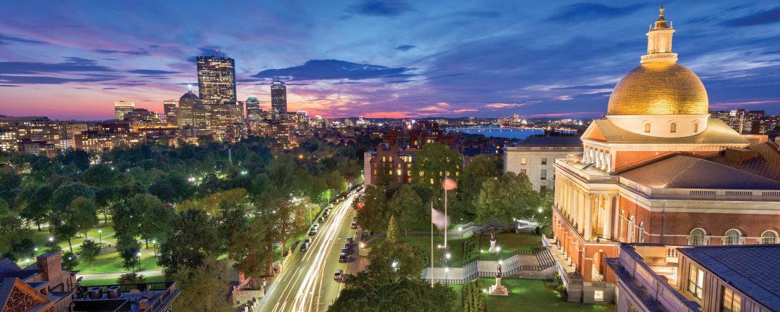 View of the Capitol building in Boston at night showing the city skyline