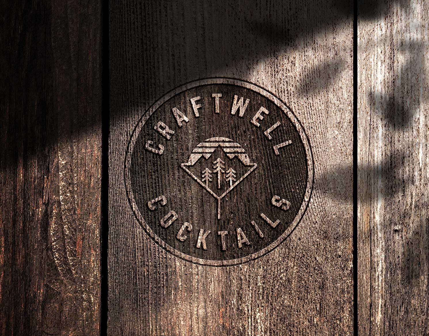 Craftwell Cocktails logo burned on wood