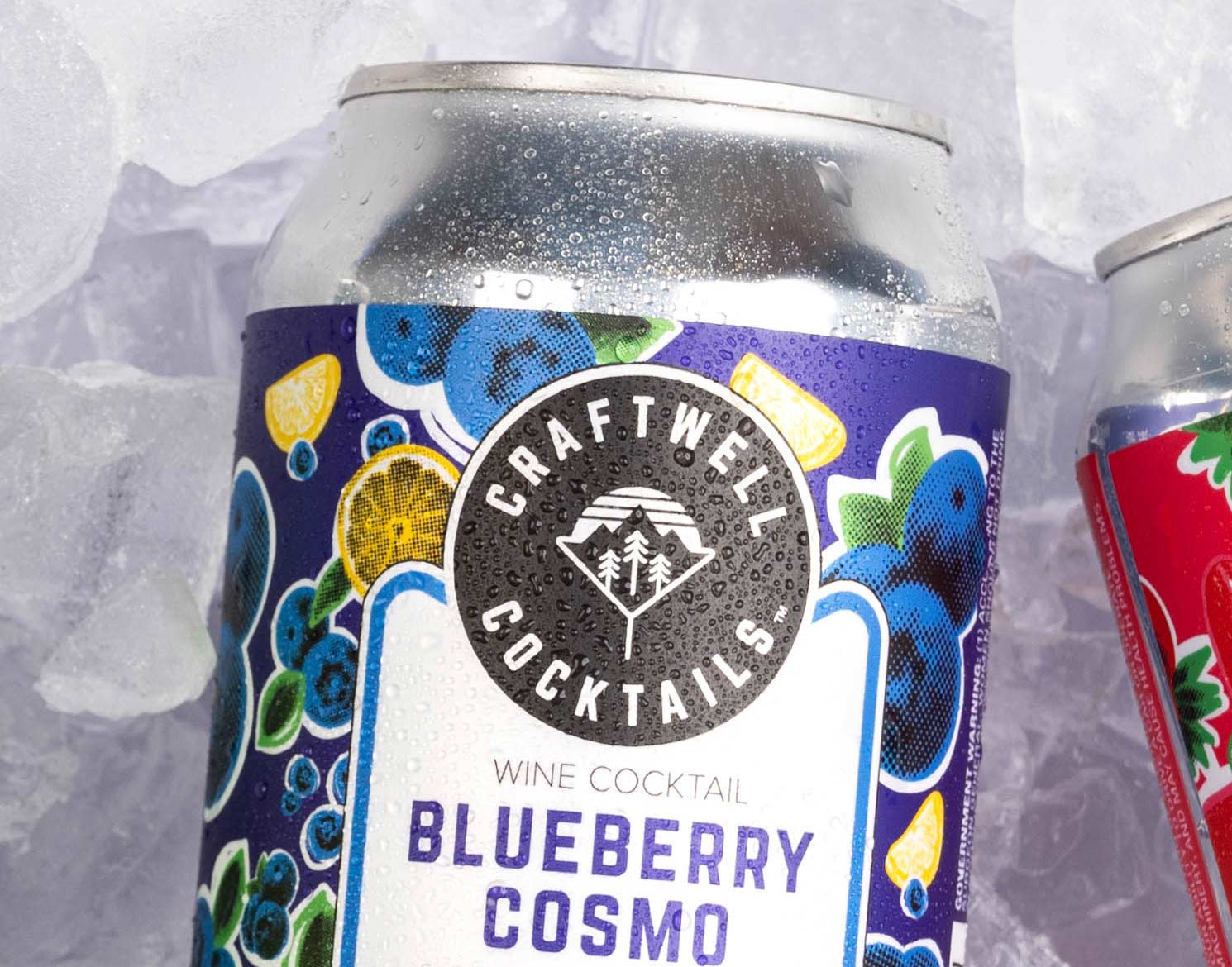 closeup of Craftwell Cocktails blueberry cosmo can on top of a bed of ice