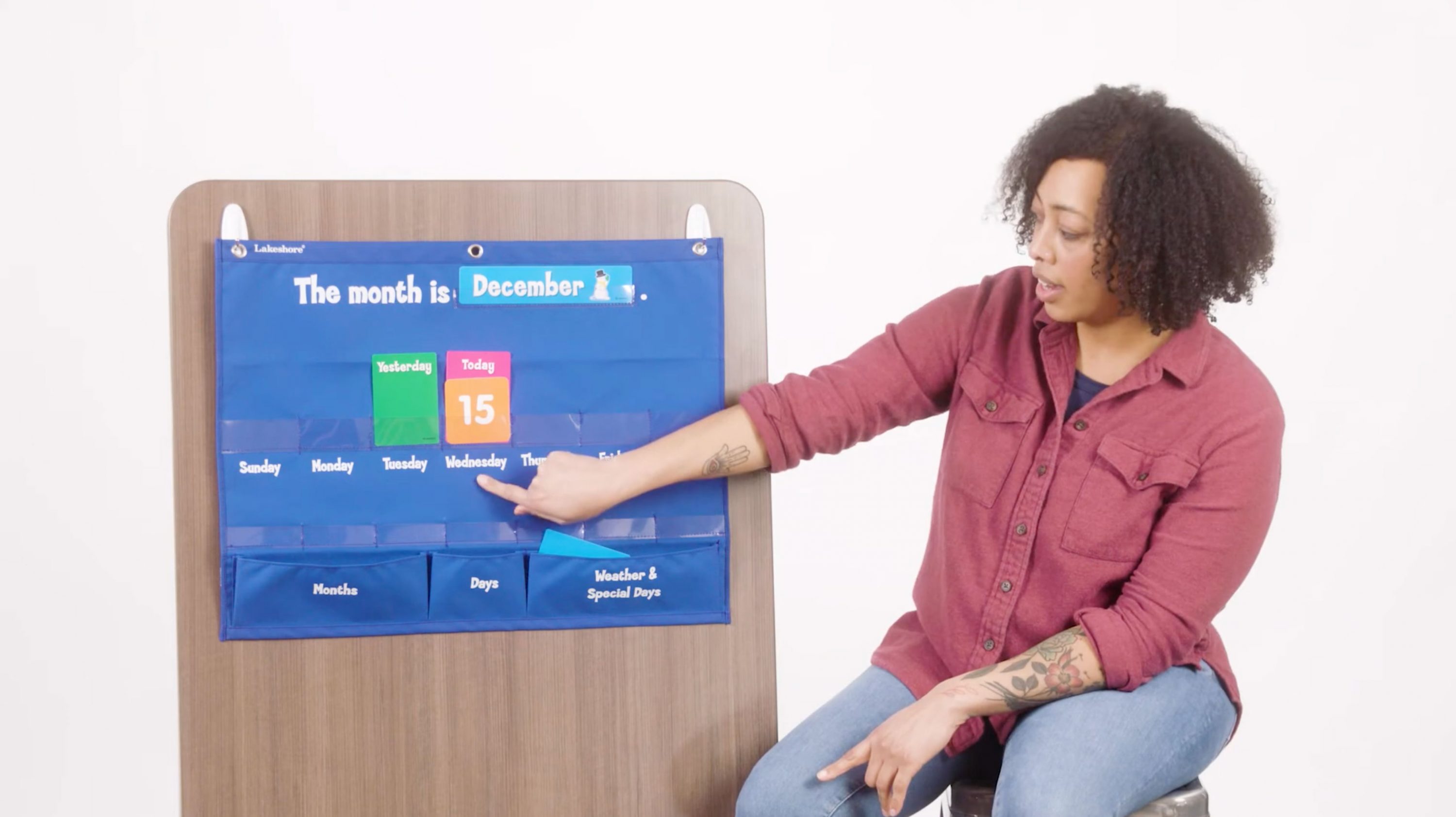 Teacher demonstrating 'Circle Time' with an interactive calendar